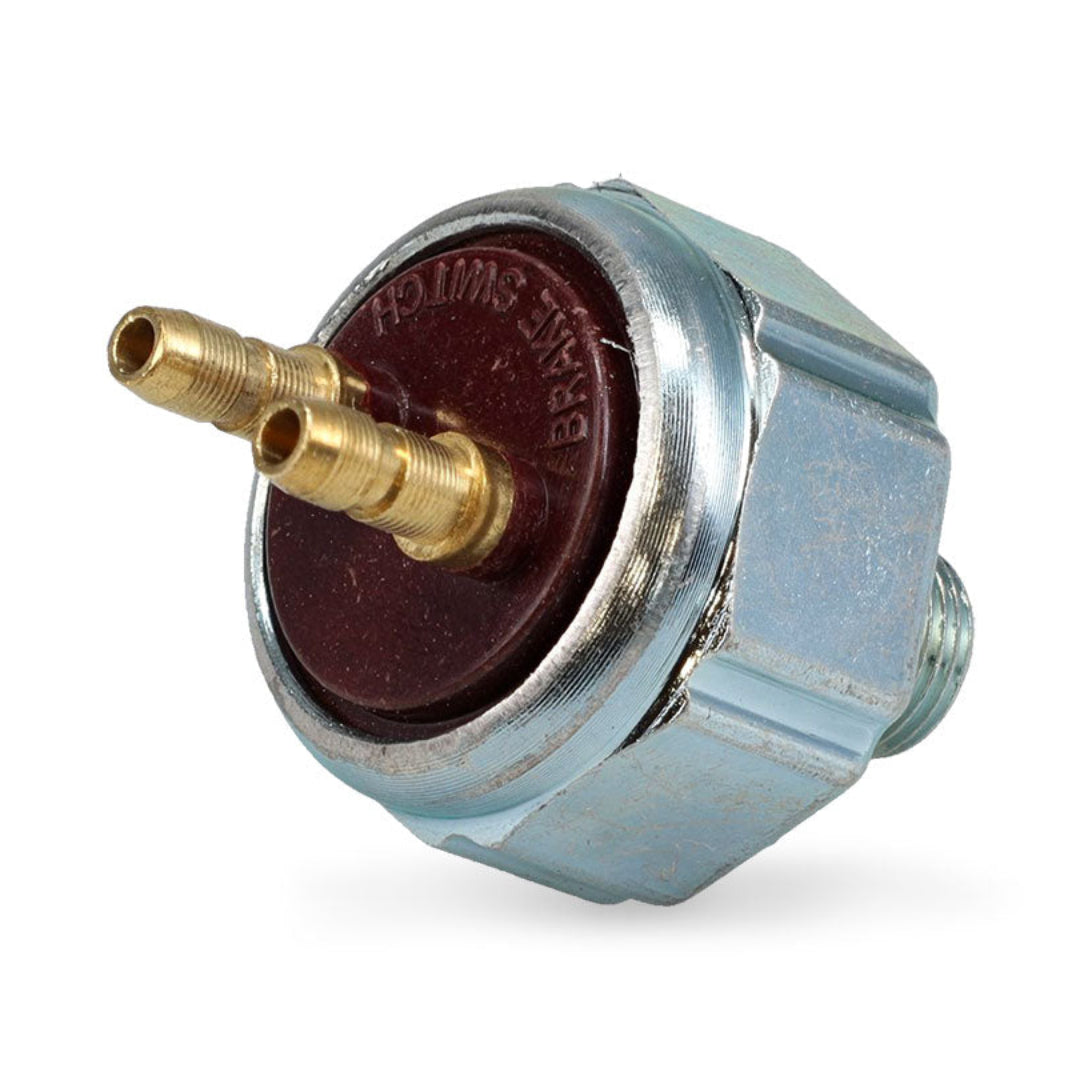 Red brake light switch with metal bracket and wiring connectors, side view