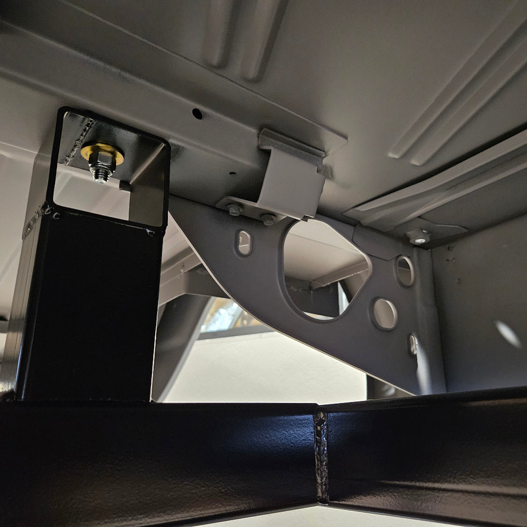 Black metal fuel tank bracket with mounting holes, rear view