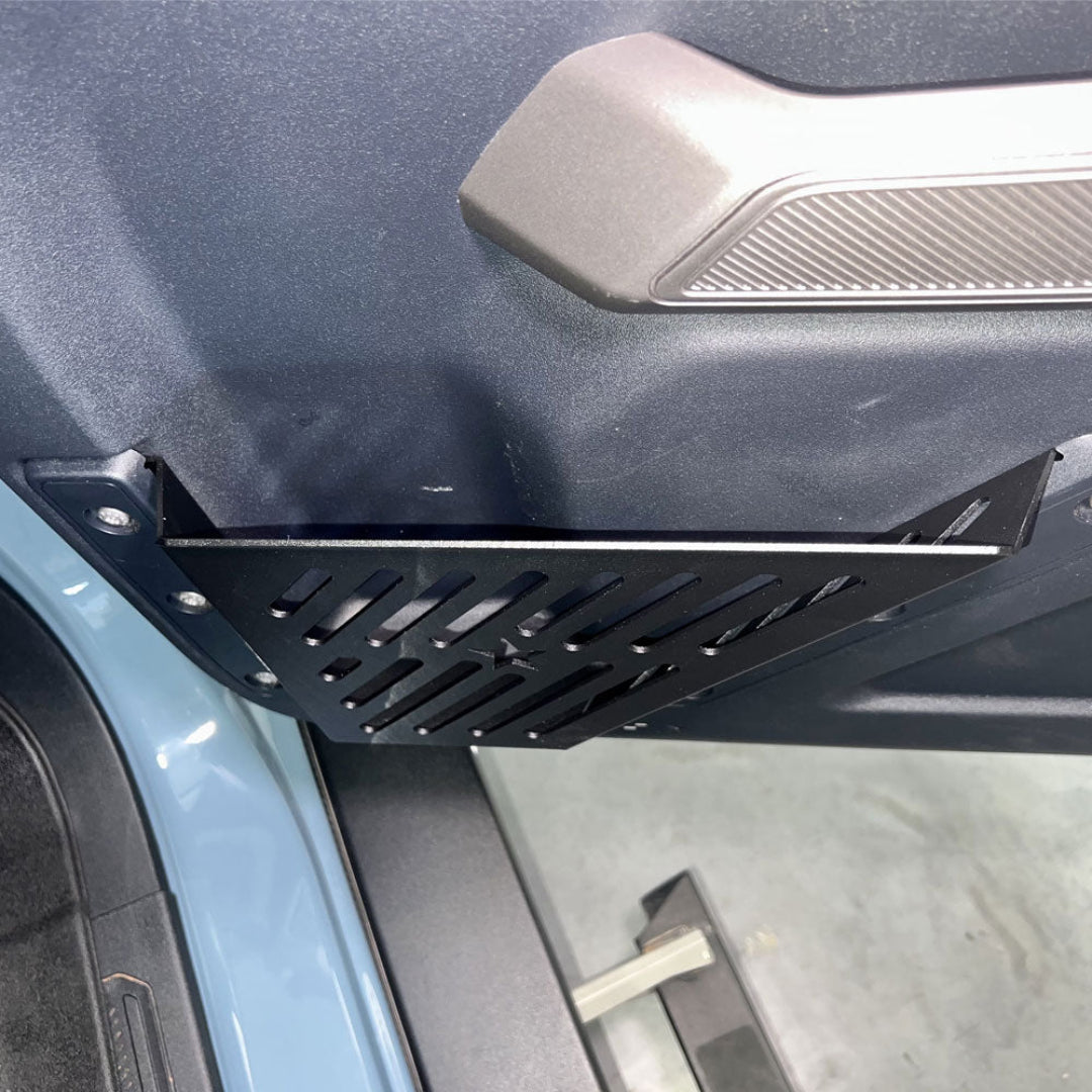 Silver aluminum door pockets with textured finish, installed on Ford Bronco, front view