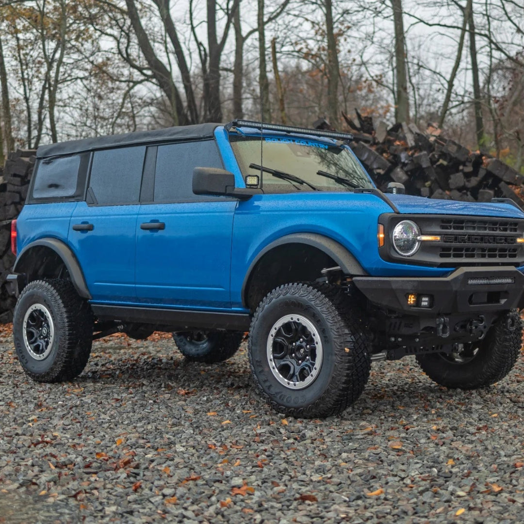 Black electric running boards with textured step surface, mounted on Ford Bronco, side view