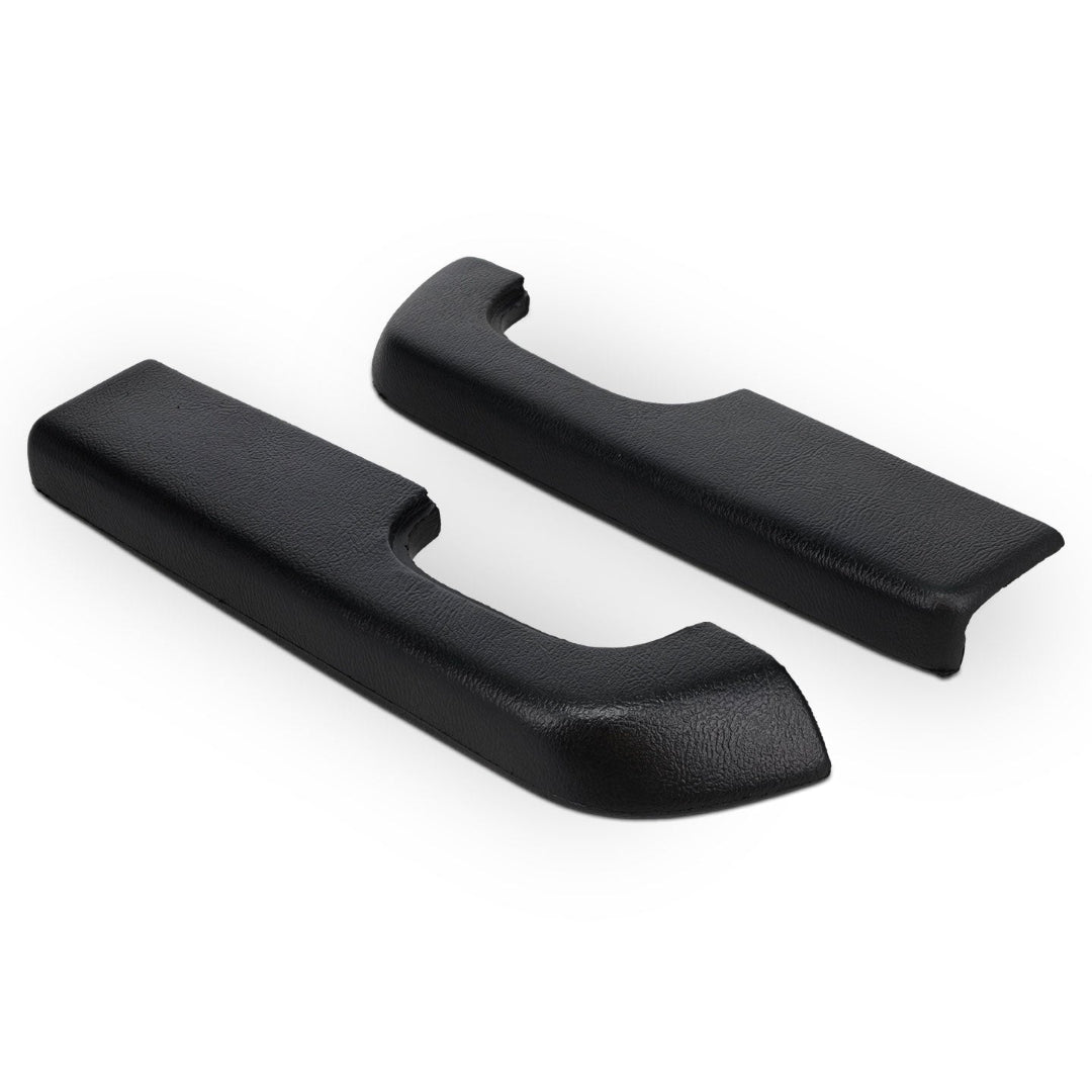 Pair of black arm rest pads with textured surface, side view