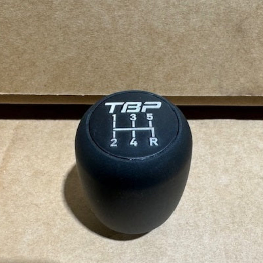Black leather shift knob with old logo engraving, top view