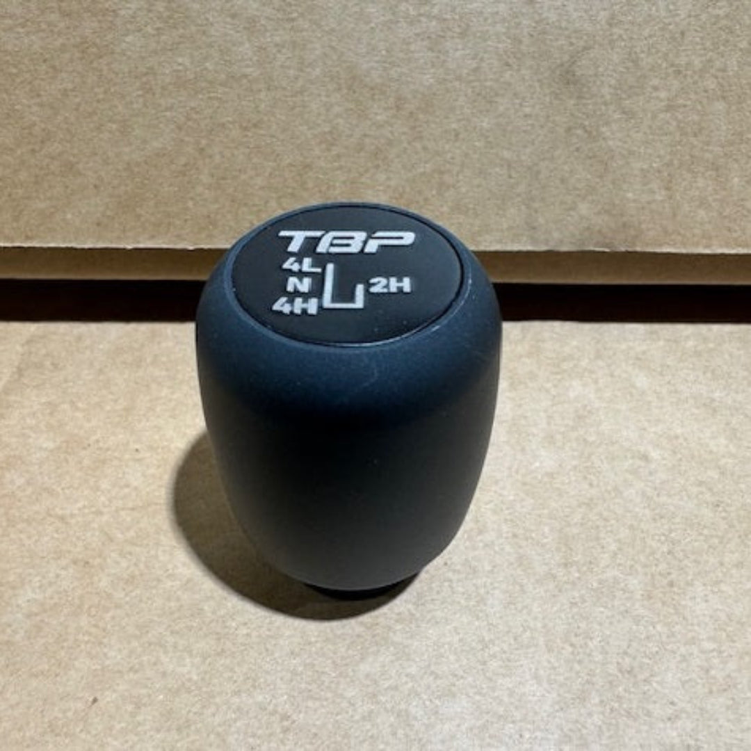 Black metal shift knob with old logo, side view