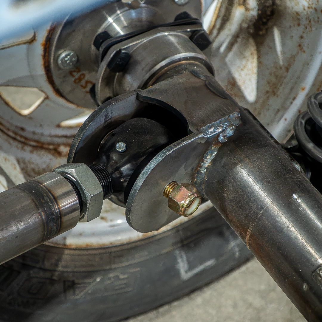 Black steel 4-link suspension kit with coil-over shock mounts, side view