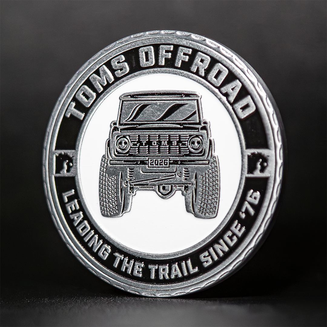 Limited edition silver coin with offroad design, front view