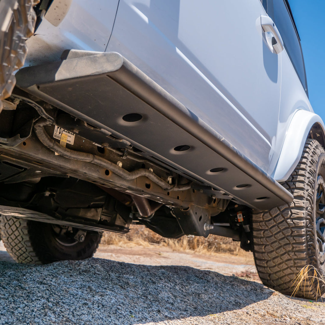 Black steel step-slider with textured tread plates, side view