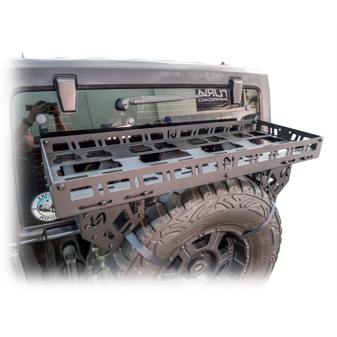 Black steel spare tire rack with mounting hardware, side view