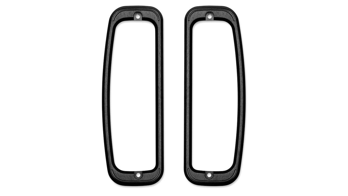 Pair of black billet aluminum tail light bezels, angled view