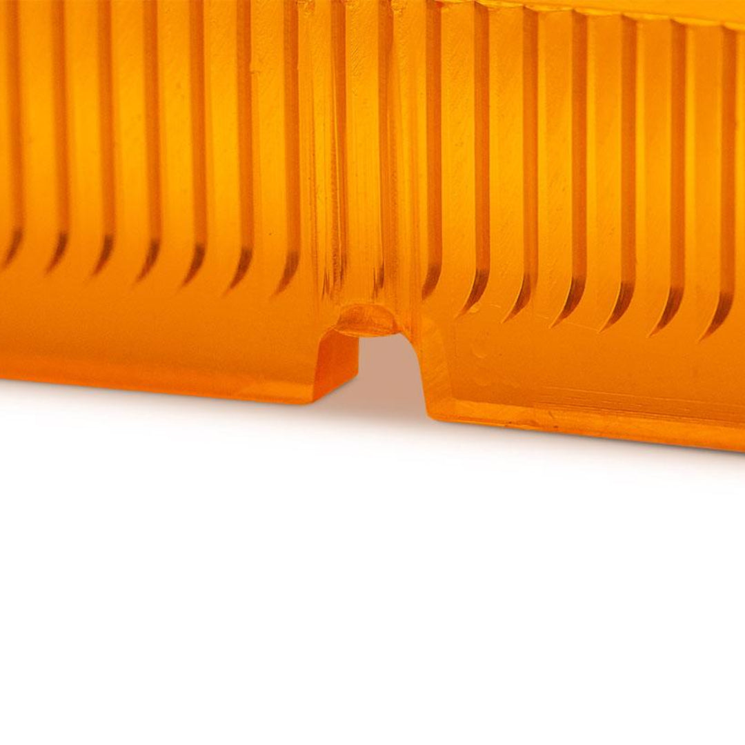 Amber plastic turn signal lens with textured surface, front view