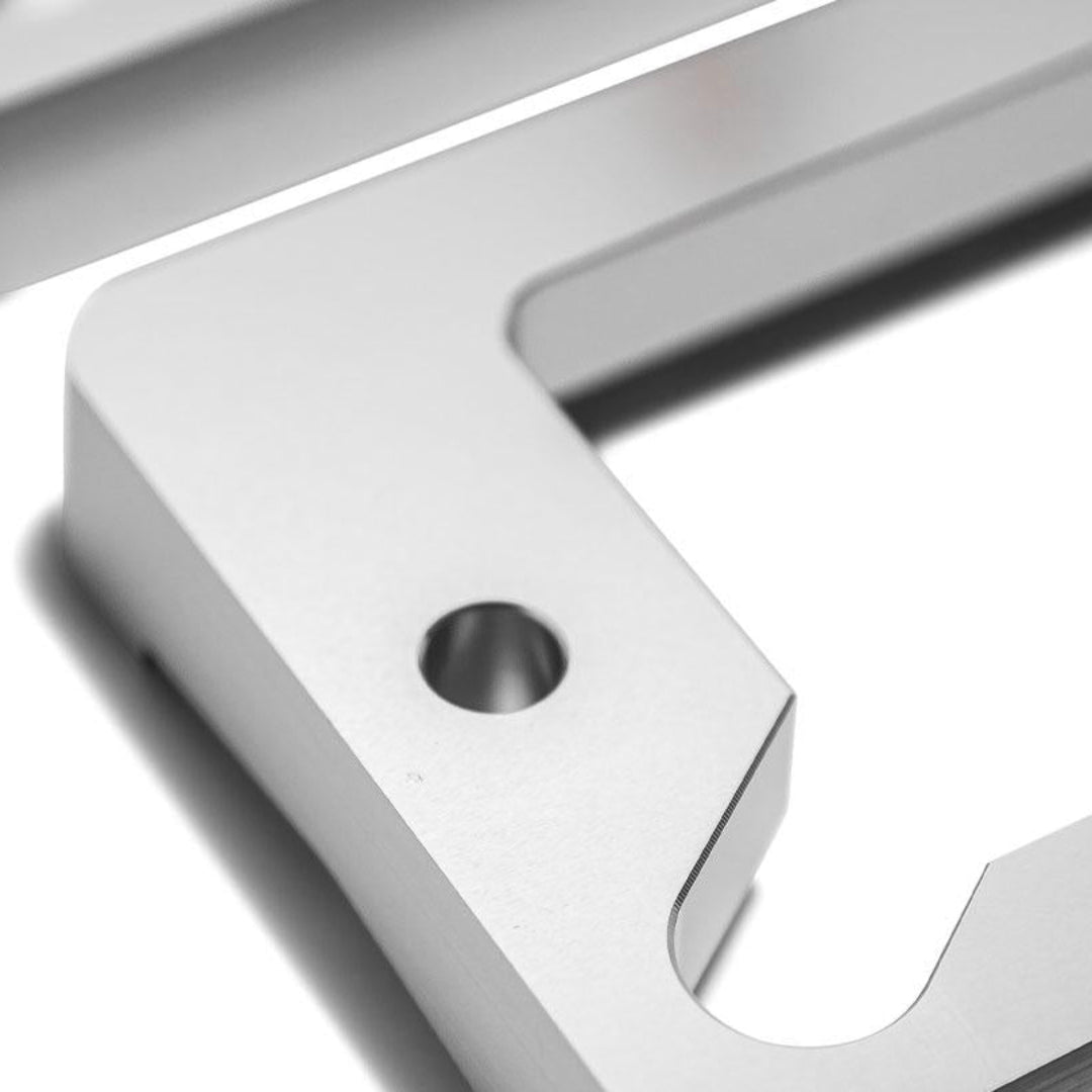 Polished aluminum turn signal bezels with mounting hardware, front view