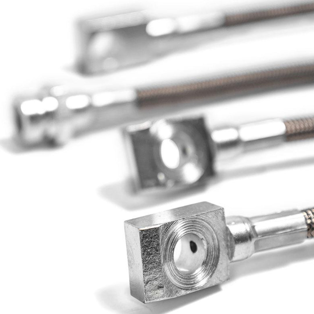 Braided stainless steel brake hose kit with silver fittings, close-up detail