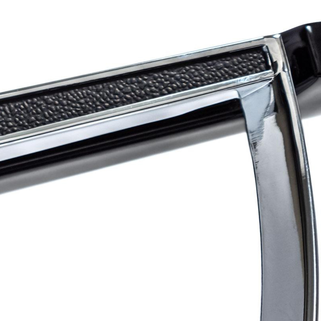 Black steering wheel with chrome horn ring, three-spoke design, front view