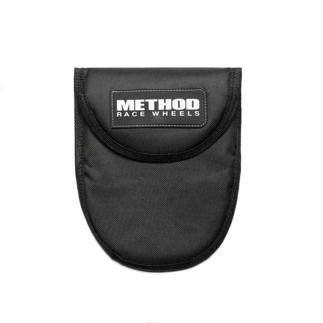 Compact black air deflator with pressure gauge and quick-release valve, front view