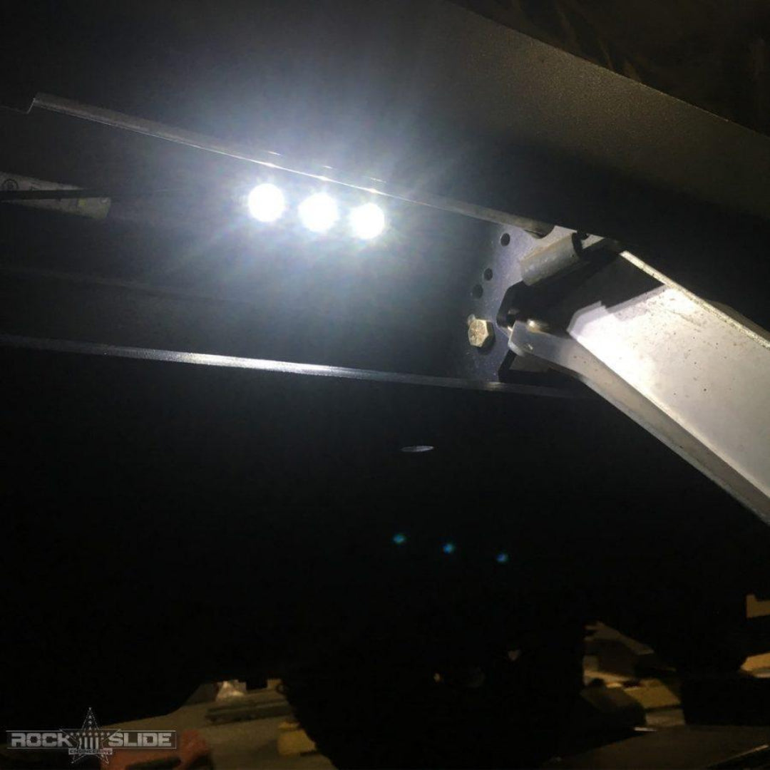 Black LED light bar with rock slider step, side view on off-road vehicle