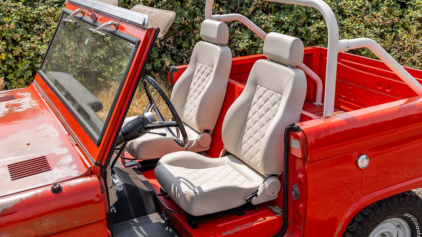 Classic Ford Bronco Restoration Project Showing Parts, Tools, And Bodywork.