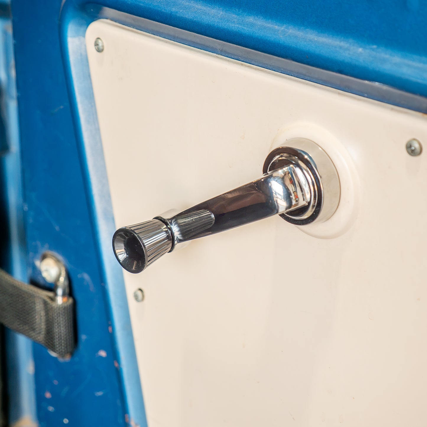 Chrome window crank handle with black knob, side view