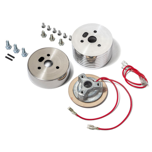 Polished silver steering wheel hub with bolt pattern adapter, close-up view