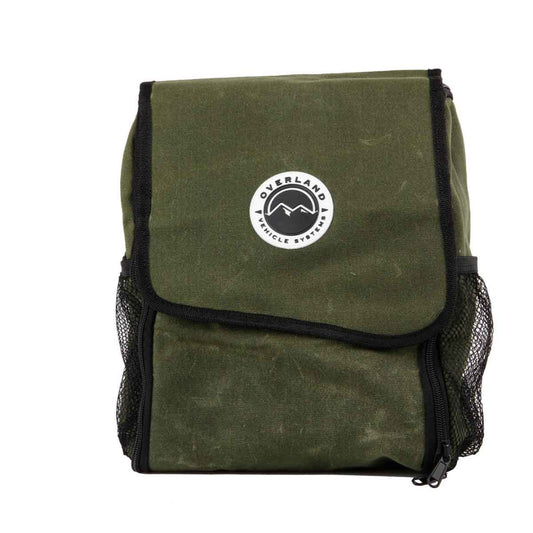 Brown canvas travel bag with leather straps and front pocket, side view