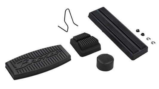 Black rubber pedal pads with raised script lettering for automatic transmission, side view