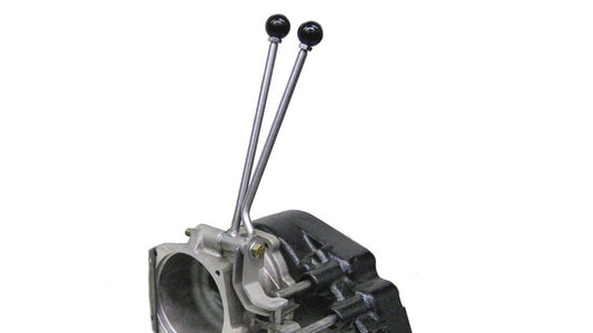 Black J-style twin stick shifter with textured knobs, top-down view