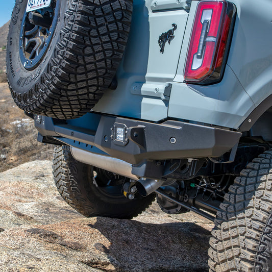 Black steel rear bumper with integrated hitch receiver and D-ring mounts for Ford Bronco, side view
