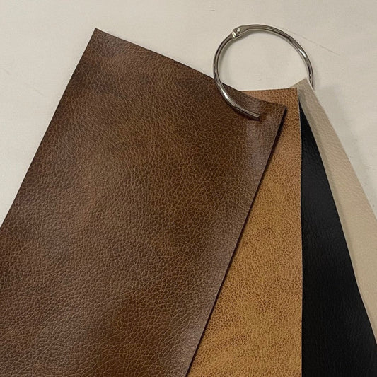 Tan fabric seat material sample with textured weave pattern, close-up